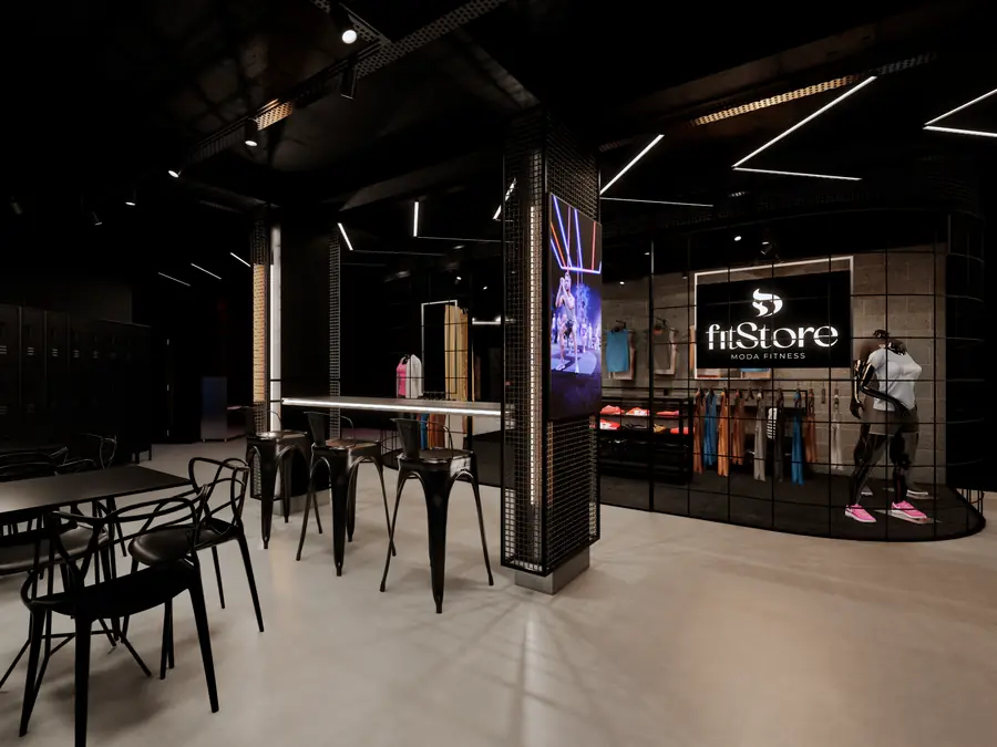 Área de convivência com mesas e a loja fitStore ao fundo